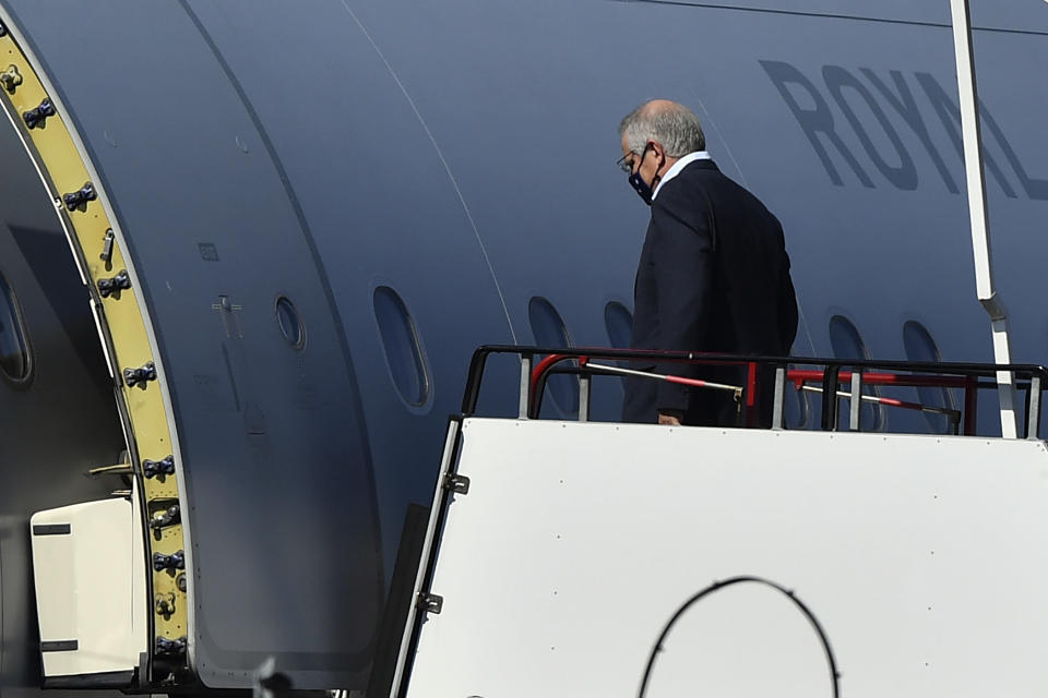 Australian Prime Minister Scott Morrison boards a Royal Australian Air Force plane in Sydney, Monday, Sept. 20, 2021. Morrison is flying to the United States for a meeting with President Joe Biden and the leaders of India and Japan that make up the Quad security forum. (Joel Carrett/AAP Image via AP)