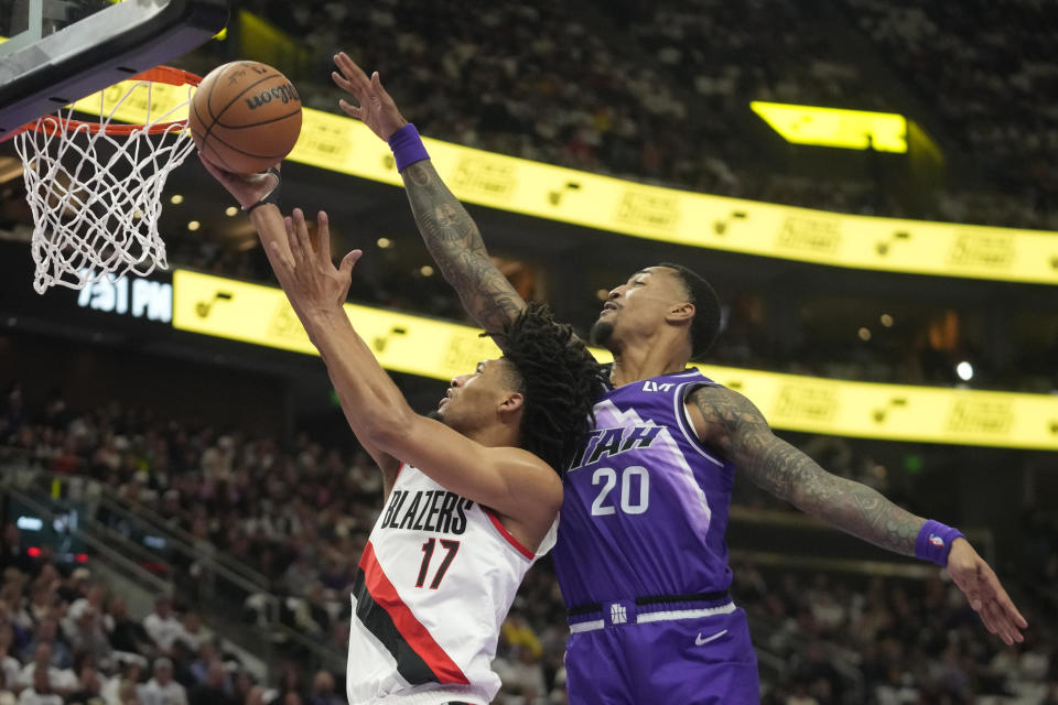 Portland Trail Blazers guard Shaedon Sharpe (17) goes to the basket as Utah Jazz forward John Collins (20) defends during the first half of an NBA basketball in-season tournament game, Tuesday, Nov. 14, 2023, in Salt Lake City. (AP Photo/Rick Bowmer)