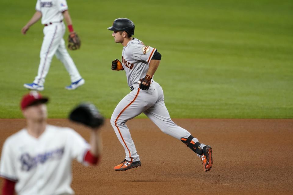 San Francisco Giants' Jason Vosler, right, rounds the bases after hitting a solo home run off of Texas Rangers' Kyle Gibson, left front, in the fifth inning of a baseball game in Arlington, Texas, Wednesday, June 9, 2021. (AP Photo/Tony Gutierrez)