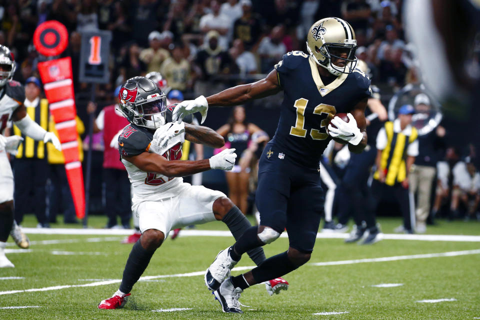 New Orleans Saints wide receiver Michael Thomas (13) breaks away from Tampa Bay Buccaneers defensive back Sean Murphy-Bunting on a touchdown reception in the second half of an NFL football game in New Orleans, Sunday, Oct. 6, 2019. (AP Photo/Butch Dill)