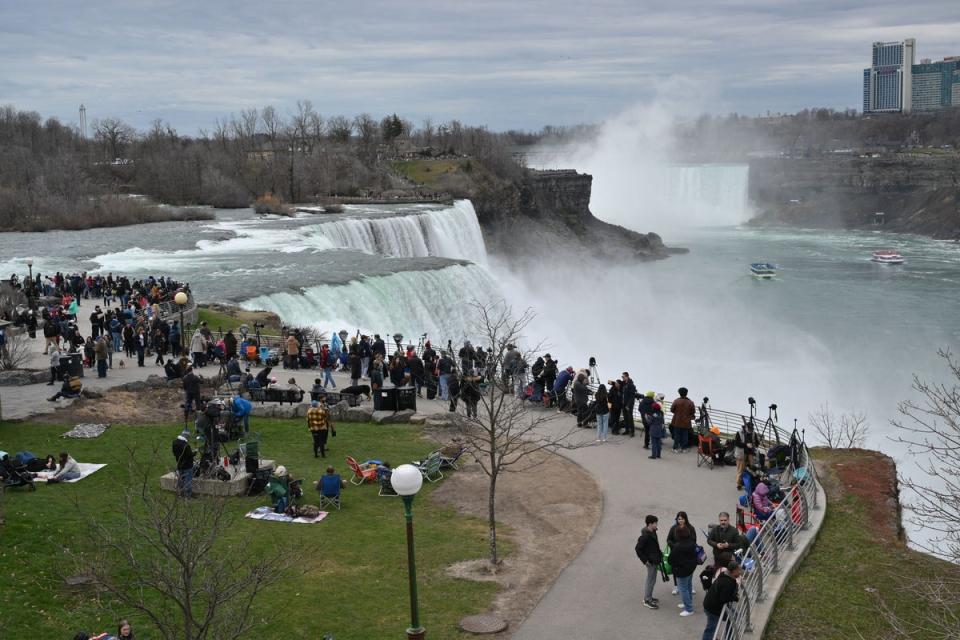 People gather at Niagara Falls State Park ahead of a total solar eclipse (AFP via Getty Images)