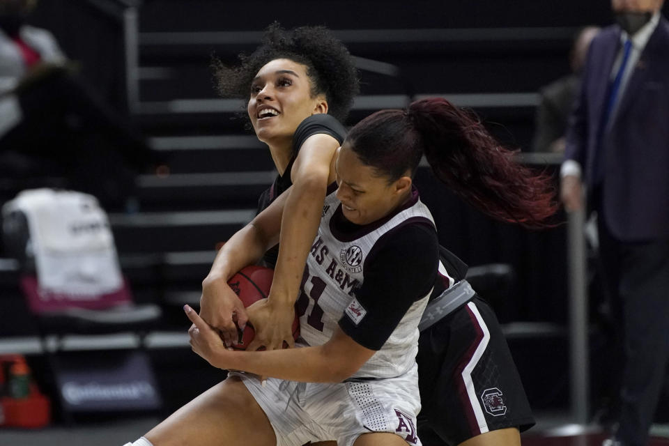 Texas A&M forward N'dea Jones (31) fights for a rebound against South Carolina guard Brea Beal (12) during the first half of an NCAA college basketball game Sunday, Feb. 28, 2021, in College Station, Texas. (AP Photo/Sam Craft)