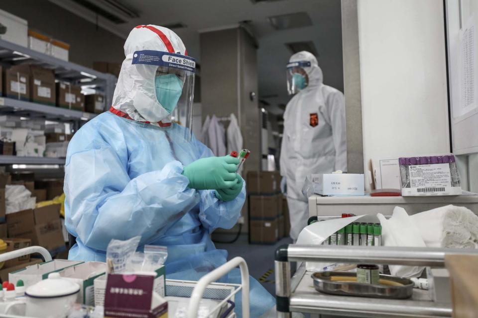 A medical worker in protective suit prepares for an RNA test at Jinyintan hospital in Wuhan (REUTERS)