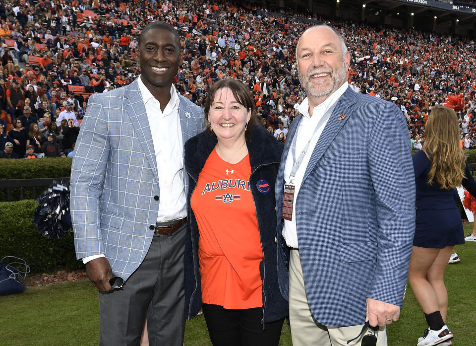 In this Nov. 17, 2018 photo provided by Auburn University Athletics, Dee Ford poses for a picture with Auburn Director of Athletics Allen Greene and Auburn University President Steven Leath before a college football game at Jordan-Hare Stadium in Auburn, Ala. An Englishwoman has seen the best and worst that Twitter would have to offer the American football player who shares her name, if he had an account. Dee Ford told the Kansas City Star she was deluged with angry tweets from Kansas City Chiefs fans who thought they were venting at linebacker Dee Ford after his late penalty during Sunday's AFC Championship loss. Oddly enough, she became a fan of the player and sport after being inadvertently tagged in a positive tweet to the player five years ago. She has spoken to the Chiefs' Dee Ford by phone and attended two games — an Auburn home game last fall and a Chiefs game in London in 2015. (Todd Van Emst/Auburn University Athletics via AP)