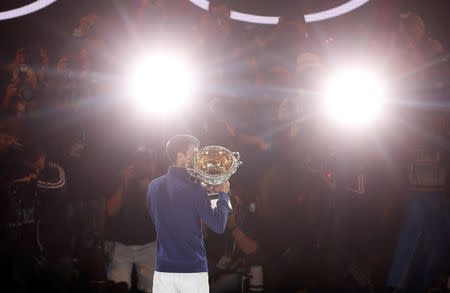 Serbia's Novak Djokovic kisses the men's singles trophy after winning his final match against Britain's Andy Murray at the Australian Open tennis tournament at Melbourne Park, Australia, January 31, 2016. REUTERS/Brandon Malone