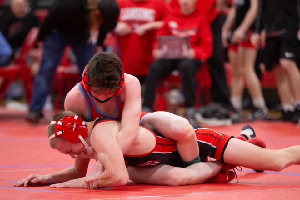 Shawnee Heights' Tristan Buce looks to pin Lansing's Caden Garcia in their class 106 bout at the United Kansas Conference Championship Saturday, February 3, 2024, inside Shawnee Heights High School.