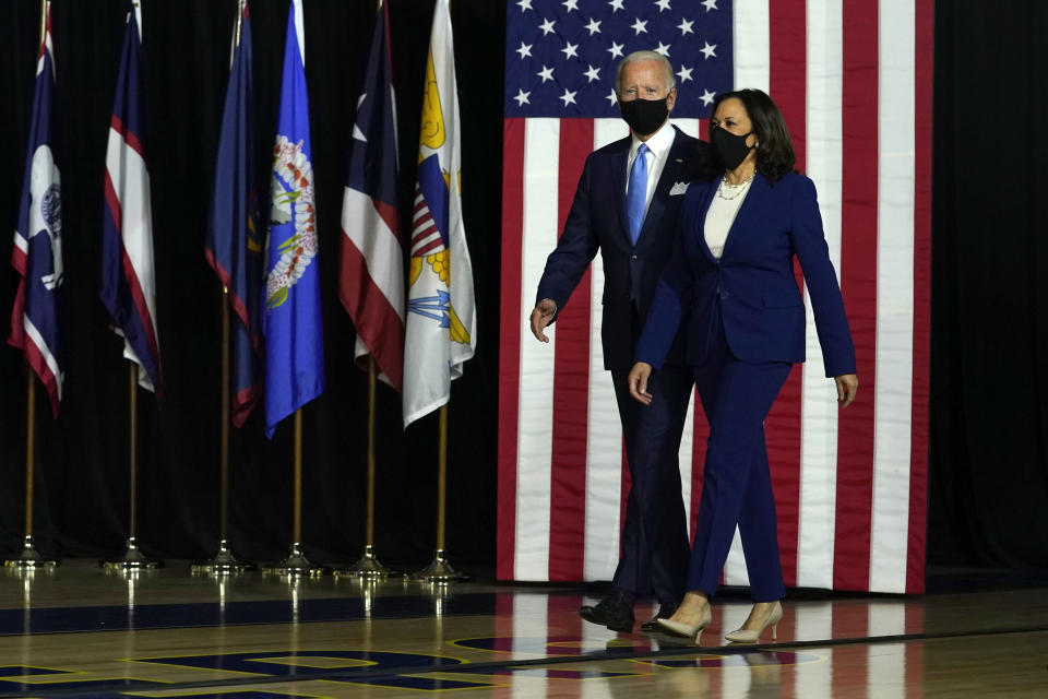 Democratic presidential candidate former Vice President Joe Biden and his running mate Sen. Kamala Harris, D-Calif., arrive to speak at a news conference at Alexis Dupont High School in Wilmington, Del., Wednesday, Aug., 12, 2020. (AP Photo/Carolyn Kaster)