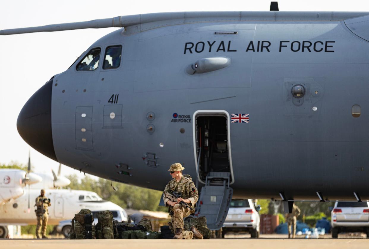 Evacuees and military personnel at Wadi Seidna airport in Khartoum, Sudan waiting to board an RAF aircraft bound for Cyprus on 29 April (PA)