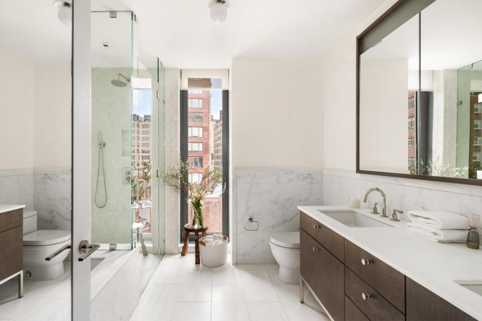 The main bathroom offers peek-a-boo city views as well as radiant-heat floors. Courtesy of property