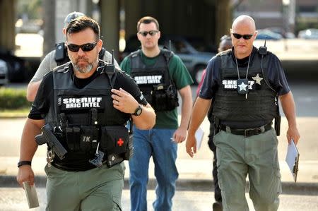 Officers arrive at the Orlando Police Headquarters during the investigation of a shooting at the Pulse nightclub, where people were killed by a gunman, in Orlando, Florida, U.S June 12, 2016. REUTERS/Steve Nesius