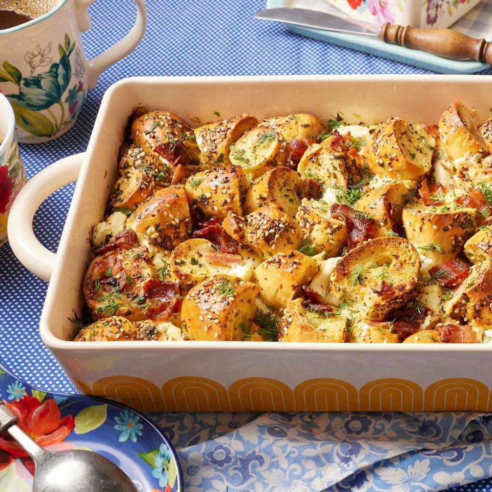 easter brunch ideas everything bagel casserole in white and yellow dish with blue napkin