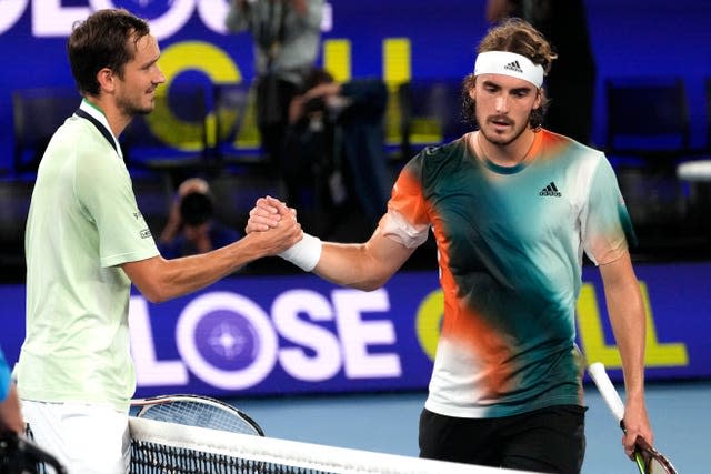 Stefanos Tsitsipas, right, shakes hands with Daniil Medvedev 