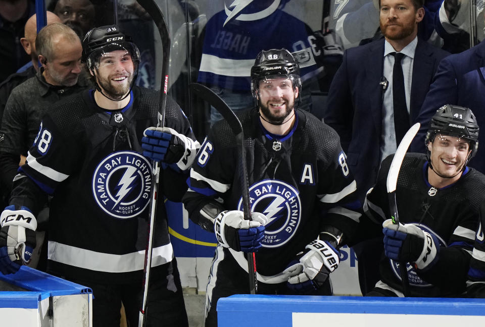 Tampa Bay Lightning's Nikita Kucherov (86) celebrates his 100th assist of the season with Brandon Hagel (38) and Mitchell Chaffee (41), during the second period of an NHL hockey game against the Toronto Maple Leafs on Wednesday, April 17, 2024, in Tampa, Fla. (Frank Gunn/The Canadian Press via AP)