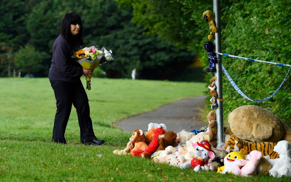 A woman laying flowers near the river where the boy was found - Wales News