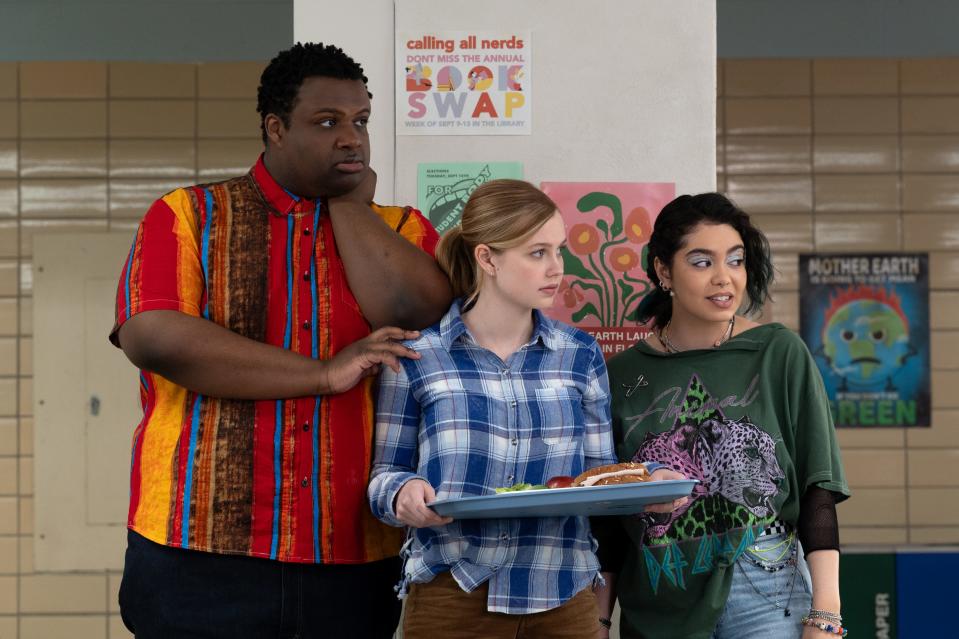 Cady Heron (Angourie Rice, center) leans on new friends Damian (Jaquel Spivey) and Janis (Auli'i Cravalho) on her first day of school in the musical "Mean Girls."