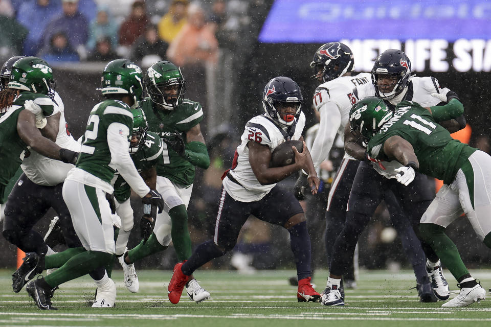 Houston Texans running back Devin Singletary (26) carries the ball against the New York Jets during the first half of an NFL football game, Sunday, Dec. 10, 2023, in East Rutherford, N.J. (AP Photo/Adam Hunger)