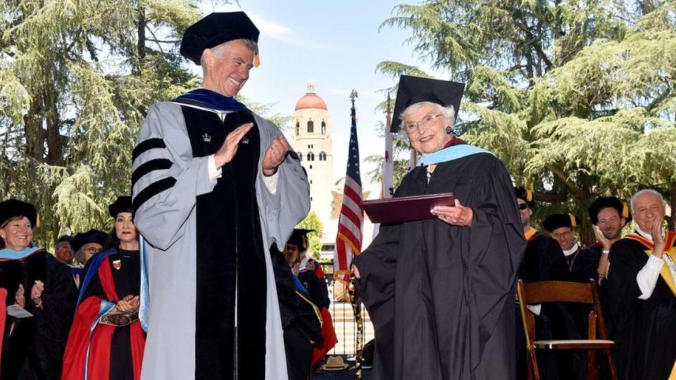 woman receiving diploma on stage