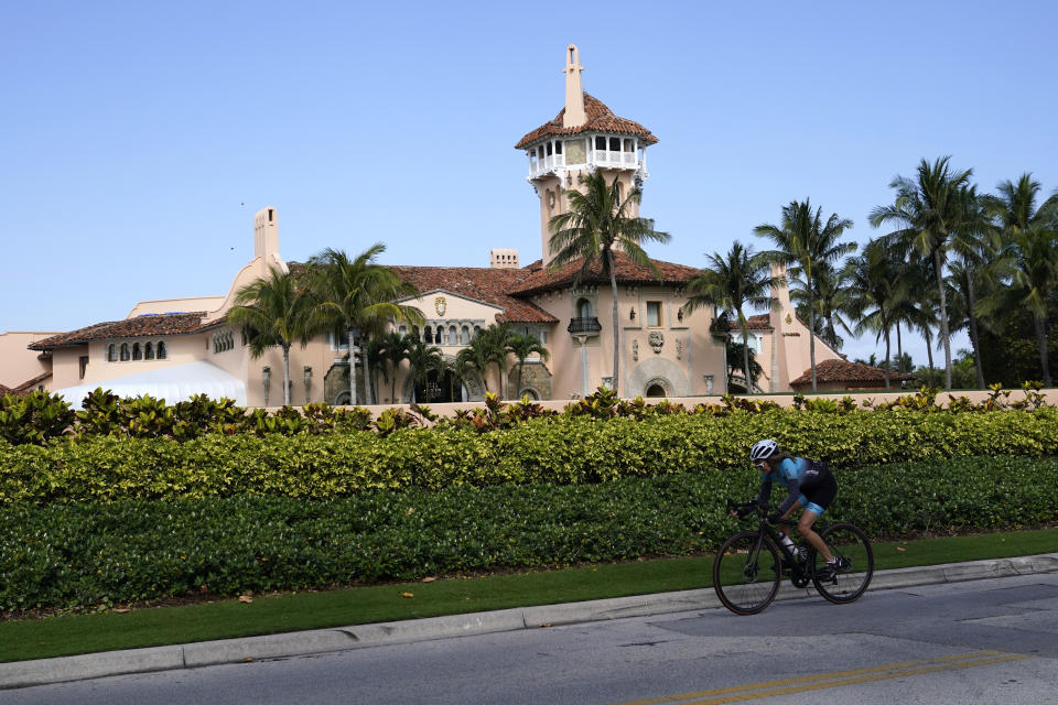 A cyclist rides past former President Donald Trump's Mar-a-Lago estate, Monday, March 20, 2023, in Palm Beach, Fla. (AP Photo/Lynne Sladky)