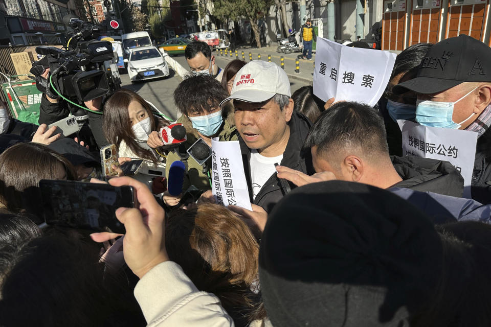 Jiang Hui, center, whose mother was on the missing MH370, speaks to journalists in Beijing Monday, Nov. 27, 2023. A Beijing court began compensation hearings Monday morning for Chinese relatives of people who died on a Malaysia Airlines plane that disappeared in 2014 on a flight to Beijing, a case that remains shrouded in mystery after almost a decade. (AP Photo/Ng Han Guan)