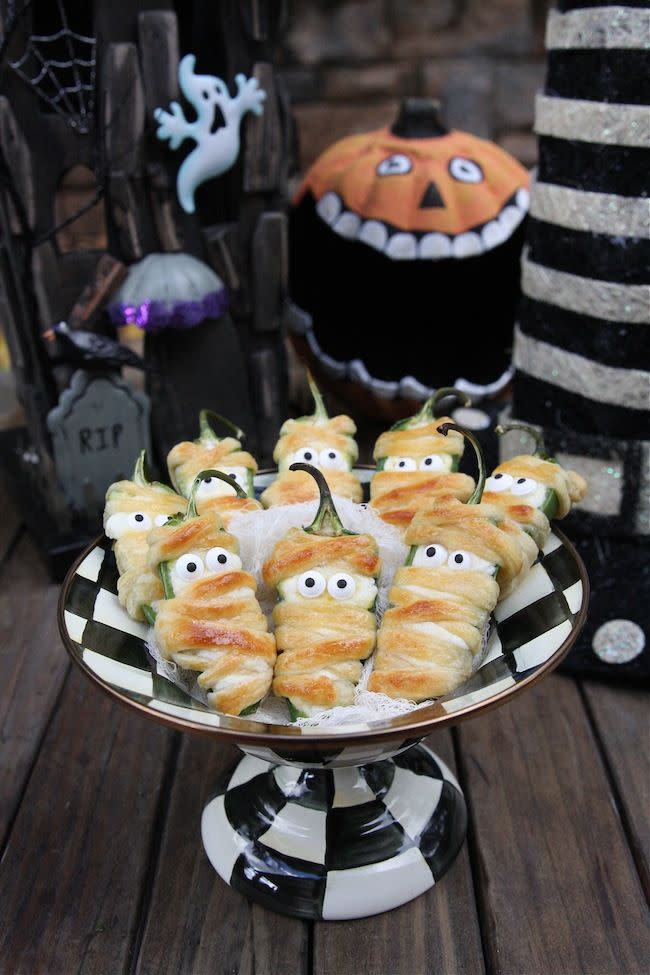 <p>Tbh, jalapeño poppers were our go-to party snack already. Transform them into mummies with a lil help from some puff pastry.</p><p><a href="https://www.thehopelesshousewife.com/?hhw_recipes=halloweeno-jalapeno-popper-mummies#.VjGQBITn-mR" rel="nofollow noopener" target="_blank" data-ylk="slk:Recipe from The Hopeless Housewife" class="link "><em>Recipe from The Hopeless Housewife</em></a></p>