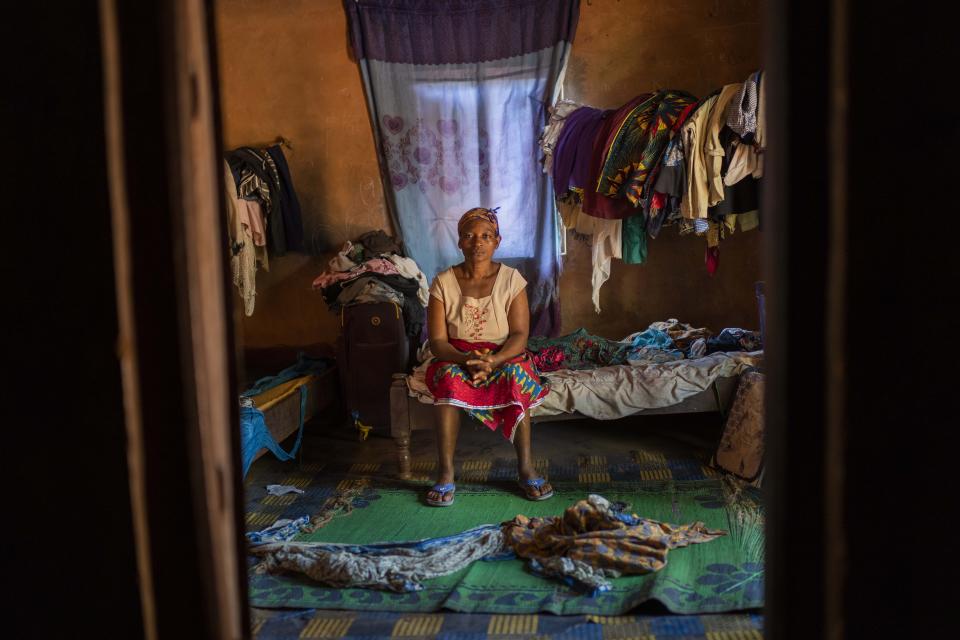 Roseline Ujah, 49, sits on her bed in Umuida, Nigeria, Friday, Feb. 11, 2022. Ujah's husband Godwin fell severely ill with a fever and cough. Everyone assumed at first that the palm wine tapper had contracted malaria, but then he failed to improve on medications for that disease. Doctors at a local hospital diagnosed him with COVID-19, though there were no tests available locally to confirm their suspicion. (AP Photo/Jerome Delay)