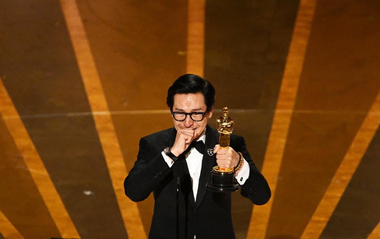 Ke Huy Quan accepts the Oscar for best actor in a supporting role during the Academy Awards in Hollywood, Calif. (Patrick T. Fallon / AFP via Getty Images)