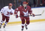 Russian President Vladimir Putin takes part in a friendly ice hockey match in the Bolshoi Ice Palace near Sochi January 4, 2014. REUTERS/Alexei Nikolskiy/RIA Novosti/Kremlin (RUSSIA - Tags: POLITICS SPORT ICE HOCKEY OLYMPICS TPX IMAGES OF THE DAY) ATTENTION EDITORS - THIS IMAGE HAS BEEN SUPPLIED BY A THIRD PARTY. IT IS DISTRIBUTED, EXACTLY AS RECEIVED BY REUTERS, AS A SERVICE TO CLIENTS