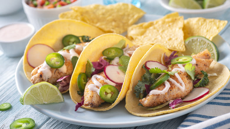 Fish tacos and tortilla chips on plate 