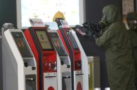 A hazmat crew scan the check in kiosk machines at Kuala Lumpur International Airport 2 in Sepang, Malaysia on Sunday, Feb. 26, 2017. Malaysian police ordered a sweep of Kuala Lumpur airport for toxic chemicals and other hazardous substances following the killing of Kim Jong Nam. (AP Photo/Daniel Chan)