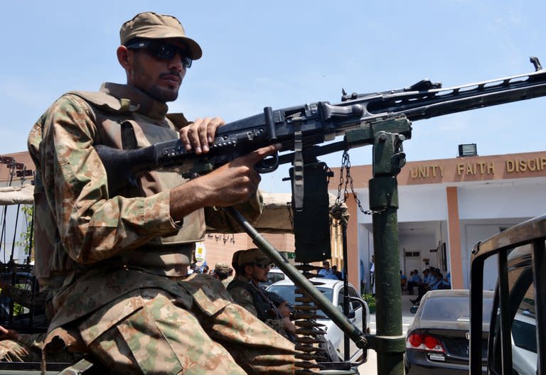 Pakistani army soldiers keep vigil at an electoral materials distribution centre in Islamabad on May 10, 2013. Bombs exploded near party political offices in remote areas of Pakistan on Friday, killing four people on the eve of a landmark general election threatened by the Taliban with suicide attacks