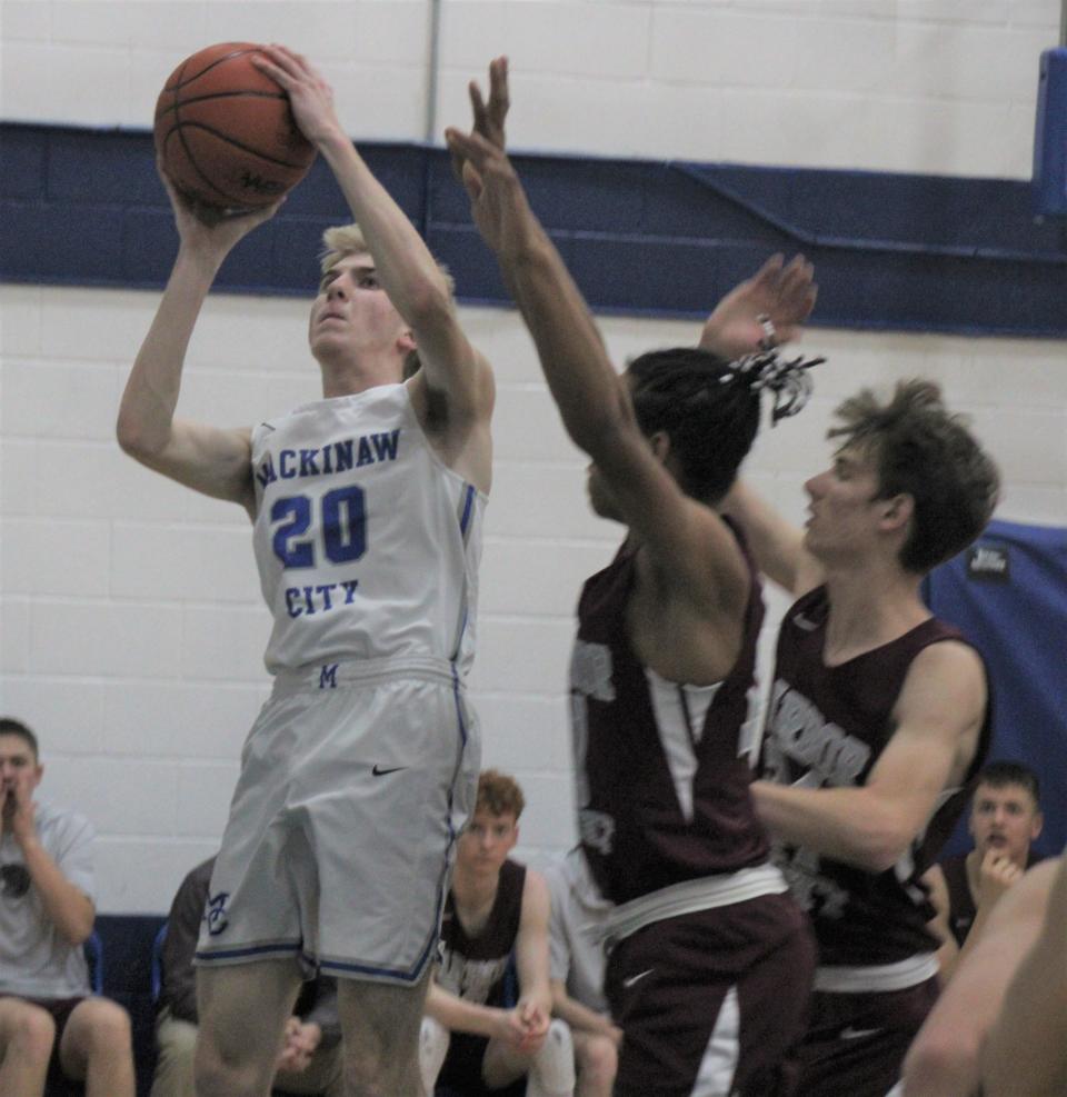 Mackinaw City senior Noah Valot (20) puts up a shot during the first half against Harbor Light on Tuesday.