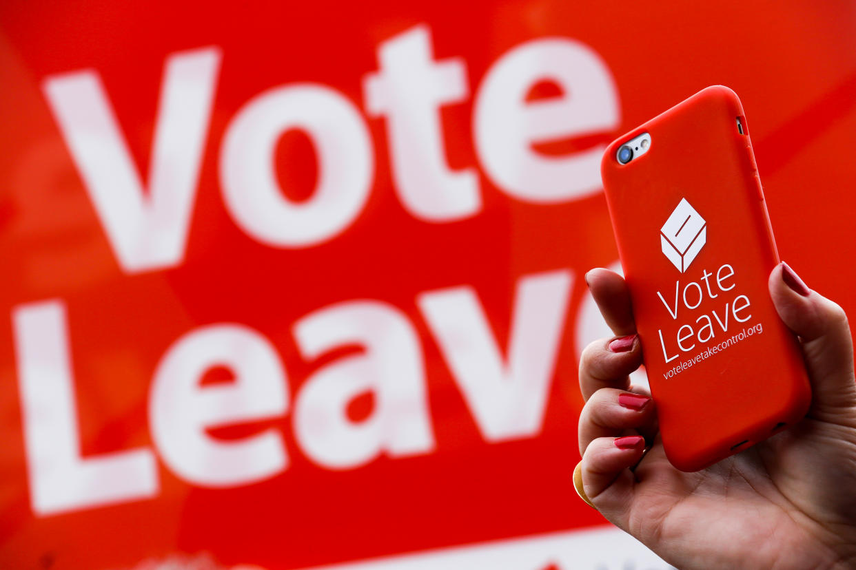 A Brexit supporter shows their support with their iPhone during the EU referendum campaign (Getty)