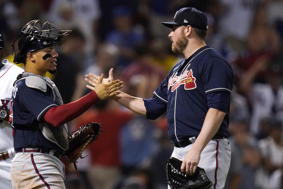 Atlanta Braves relief pitcher Tyler Matzek, right, is congratulated by catcher William Contreras after earning the save following a 9-7 win in a baseball game against the Boston Red Sox, Tuesday, Aug. 9, 2022, in Boston. (AP Photo/Charles Krupa)