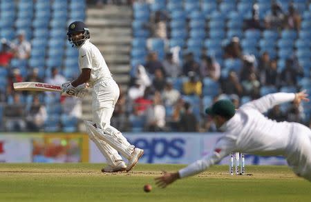 India's Shikhar Dhawan (L) watches the ball after playing a shot on the first day of their third test cricket match against South Africa in Nagpur, India, November 25, 2015. REUTERS/Amit Dave