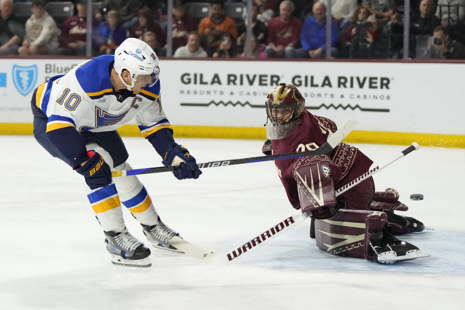 St. Louis Blues center Brayden Schenn (10) scores against Arizona Coyotes goaltender Karel Vejmelka during the first period during an NHL hockey game Wednesday, Nov. 22, 2023, in Tempe, Ariz. (AP Photo/Rick Scuteri)