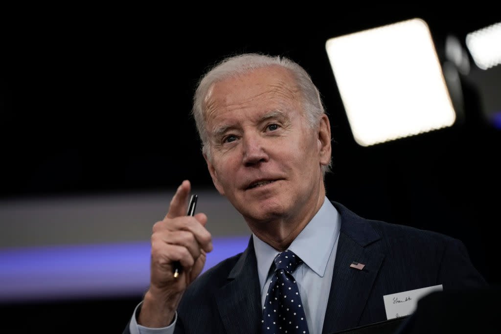 Joe Biden speaking while holding a pen in his right hand.