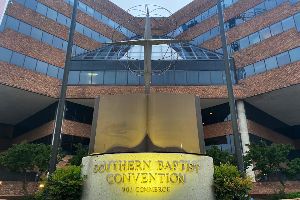 A cross and Bible sculpture stand outside the Southern Baptist Convention headquarters in Nashville, Tenn.,