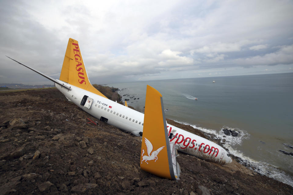 <p>A Boeing 737-800 of Turkey’s Pegasus Airlines is seen in Trabzon, Turkey, Monday, Jan. 15, 2018. A commercial airplane that skidded off a runway after landing in northern Turkey dangled precariously Sunday off a muddy cliff with its nose only a few feet from the Black Sea.Some of the 168 people on board the Boeing 737-800 described it as a “miracle” that everyone was evacuated safely from the plane, which went off a runway at Trabzon Airport. (Photo: DHA-Depo Photos via AP) </p>