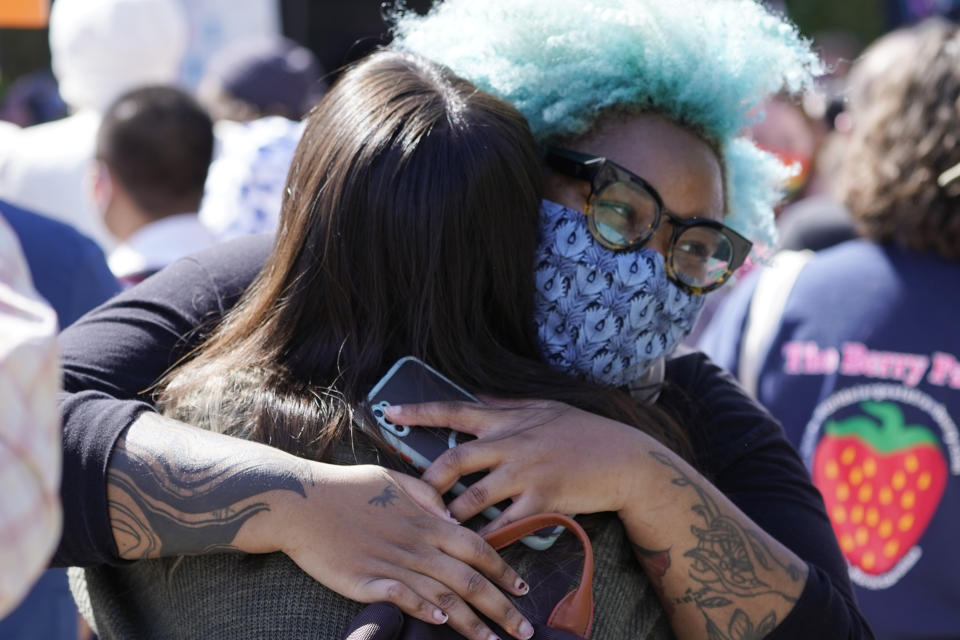 Protesters wearing face masks greet outside the Netflix building on Vine Street in the Hollywood section of Los Angeles, Wednesday, Oct. 20, 2021. Critics and supporters of Dave Chappelle's Netflix special and its anti-transgender comments gathered outside the company's offices Wednesday, with "Trans Lives Matter" and "Free Speech is a Right" among their competing messages. (AP Photo/Damian Dovarganes)