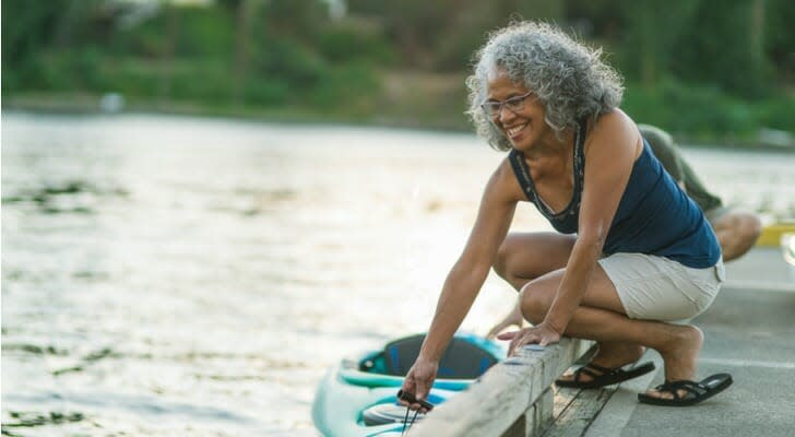 Woman putting a kayak in the water