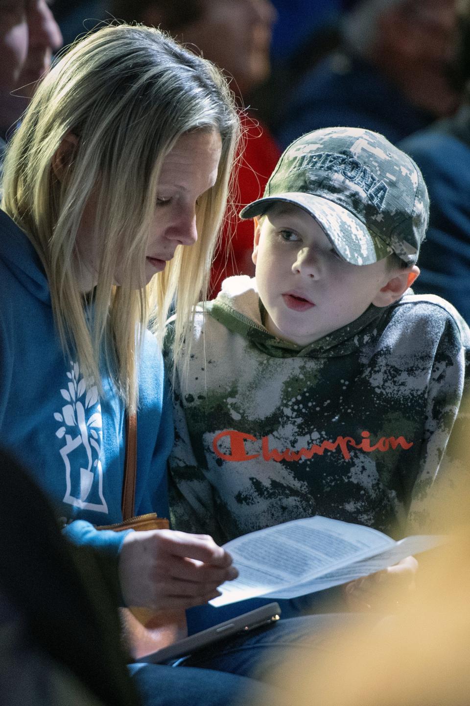 Jamie Cornell, left, of Sturbridge, and her son, Russell, 8, visited last Friday's induction ceremony for a World War II-era German rail car, part of the Holocaust exhibit at the American Heritage Museum in Hudson, Jan. 19, 2024.