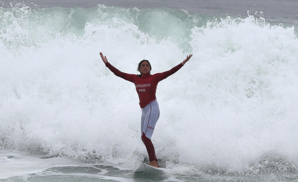 Daniella Rosas, of Peru celebrates, after wining the gold for shortboard during women's SUP surfing during the Pan American Games on Punta Rocas beach in Lima Peru, Sunday, Aug. 4, 2019. (AP Photo/Martin Mejia)