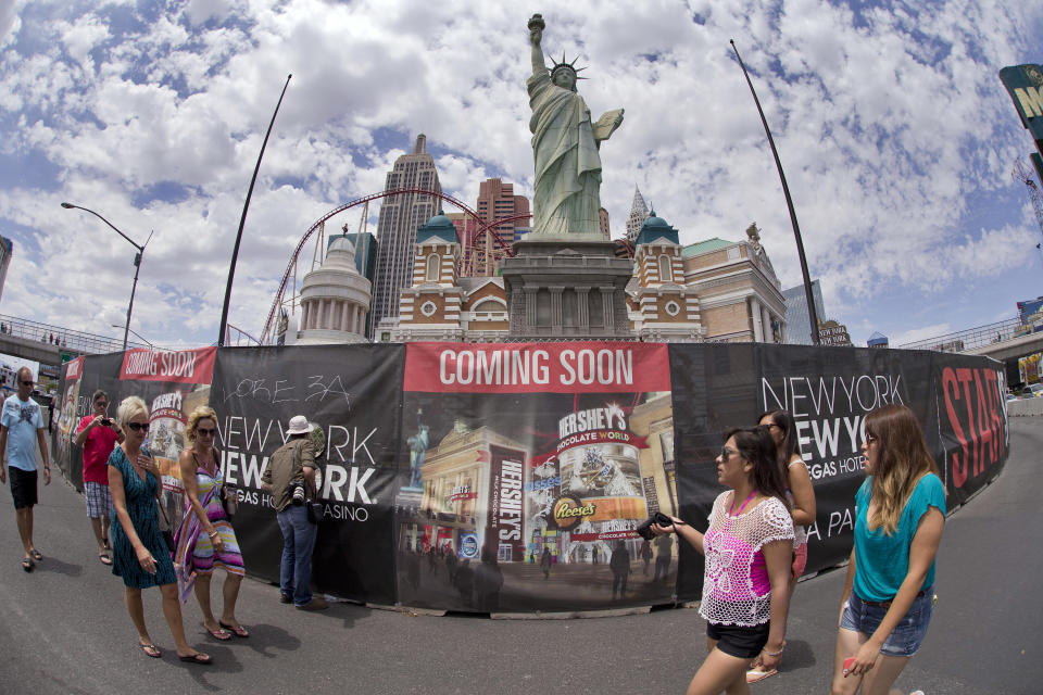 Pedestrians walk along the edge of a renovation site outside the New York-New York casino where demolition has already begun on a Sept. 11 memorial which once drew visitors, Friday, July 26, 2013, in Las Vegas. MGM Resorts International says it will relocate the memorial to make way for a $100 million renovation of the promenade in front of 16 year-old Manhattan-themed casino and the adjoining Monte Carlo. (AP Photo/Julie Jacobson)