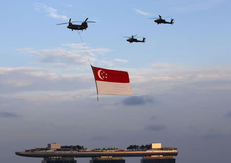 The Republic of Singapore Air Force helicopters fly past with the national flag during a Golden Jubilee celebration rehearsal in Singapore August 1, 2015. REUTERS/Edgar Su