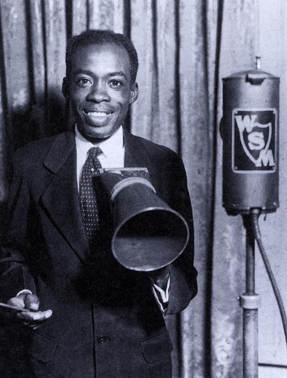 deford bailey smiling and holding a megaphone in a photograph