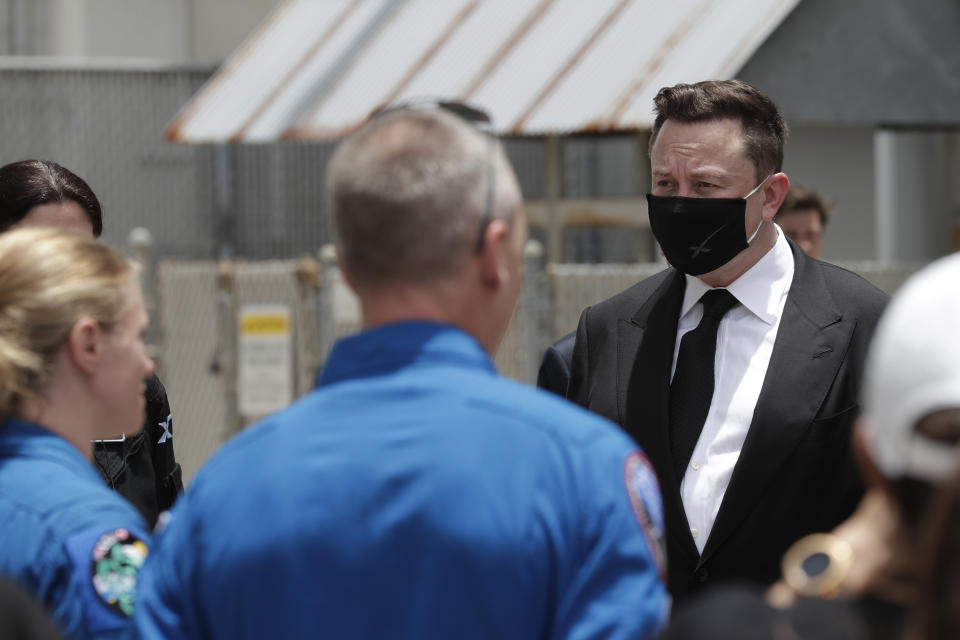 CEO of SpaceX, Elon Musk, talks to the media and NASA personnel, after astronauts Douglas Hurley, left, and Robert Behnken departed the Neil A. Armstrong Operations and Checkout Building on their way to Pad 39-A, at the Kennedy Space Center in Cape Canaveral, Fla., Wednesday, May 27, 2020. The two astronauts will fly on a SpaceX test flight to the International Space Station. For the first time in nearly a decade, astronauts will blast into orbit aboard an American rocket from American soil, a first for a private company. (AP Photo/John Raoux)