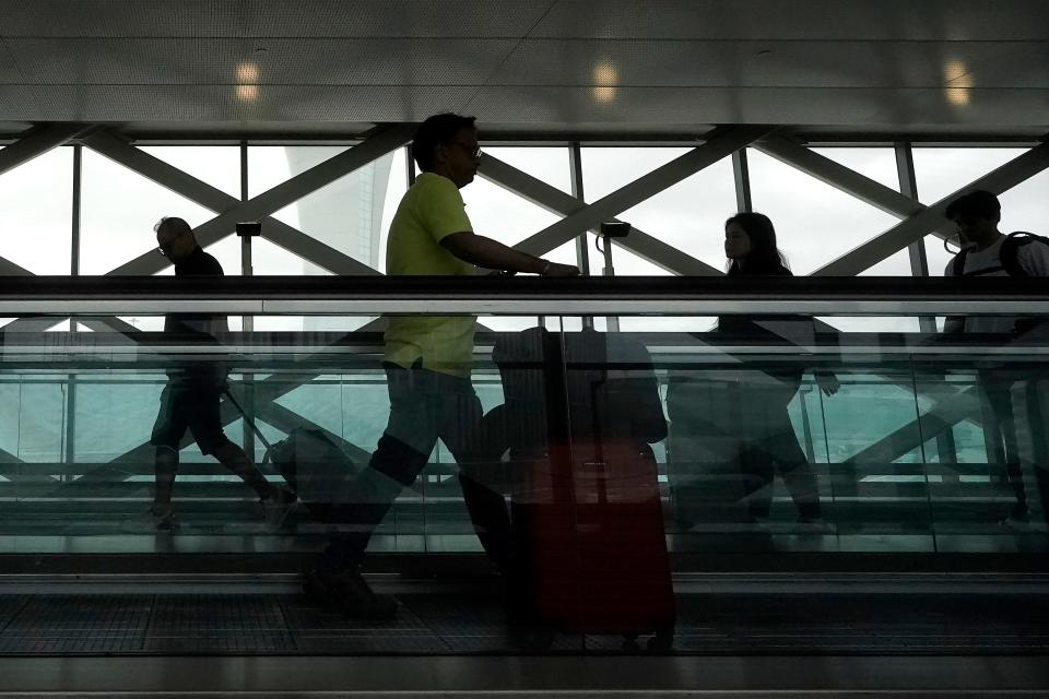 Travelers use moving walkways ahead of Memorial Day weekend in a domestic terminal at the San Francisco International Airport in San Francisco, Friday, May 26, 2023. A 57-year-old Thai woman lost her leg at Don Mueang International Airport after falling on a moving walkway there in Terminal 2.