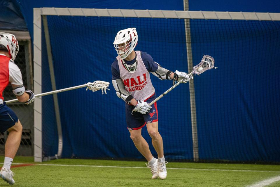 John McCurry, senior captain of Wall High School boys lacrosse team, practices for the upcoming season with his teammates at GoodSports USA in Wall, NJ Tuesday March 28, 2023.