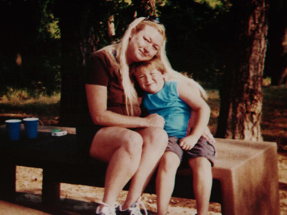 Teresa Thompson sits on a bench with her son, Anthony Templet, around the age of 5 - before his father "took" him to live with him