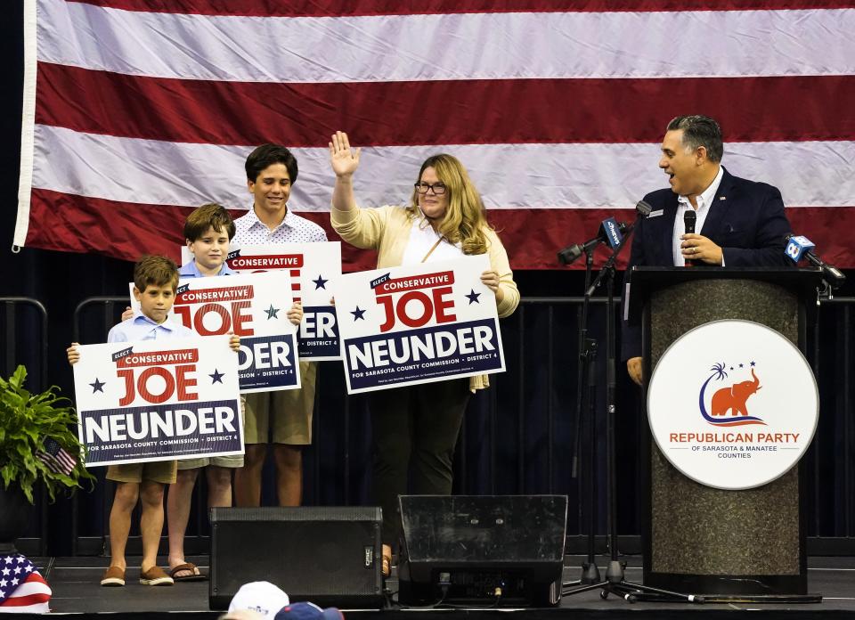 Joe Neunder takes the stage with his family at a Republican rally at Robarts Arena this summer.